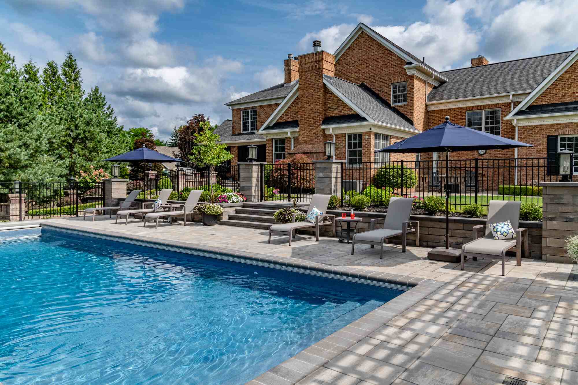 Tranquil backyard retreat with a resort-style pool and shaded lounge area in Bainbridge, OH