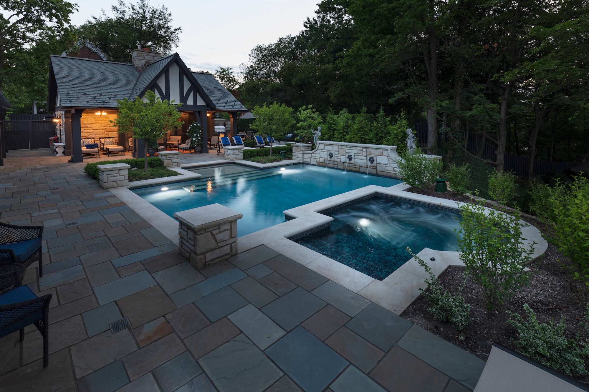 Stunning backyard pool and spa with elegant stonework at a private residence in Pepper Pike, OH